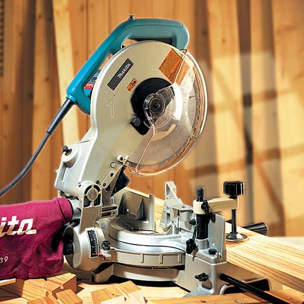 Close-up of the Makita LS1040N blade guard, vise and miter angle scale