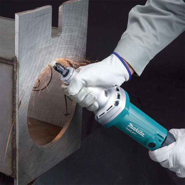 Makita M9100B 電磨以雙手握持，正在金屬工件邊緣進行研磨作業