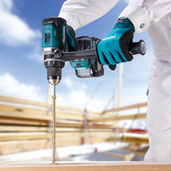 Makita DF003GZ 40V cordless driver drill driving a long screw into timber on a jobsite