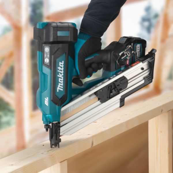 Makita BN001GZ 40V cordless framing nailer driving nails into timber on a job site