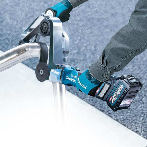 Makita BS002GZ cordless pipe belt sander polishing a stainless steel round handrail
