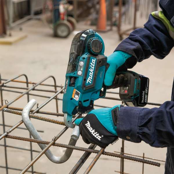 Worker tying a rebar mesh on site with the Makita DTR181Z 18V cordless rebar tying tool