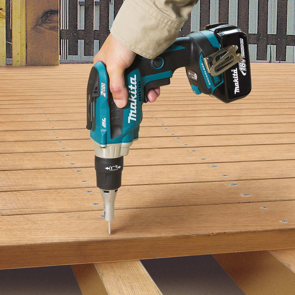 Makita DFS250Z cordless screwdriver driving screws into timber decking