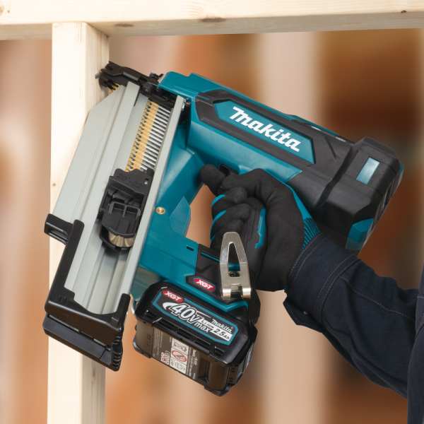 操作人員手持 Makita BN002GZ 40V 充電式框架釘槍於木結構框架接口打釘