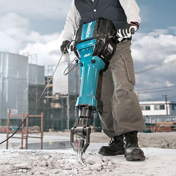 Worker breaking a concrete surface on site with the Makita HM1812 electric breaker
