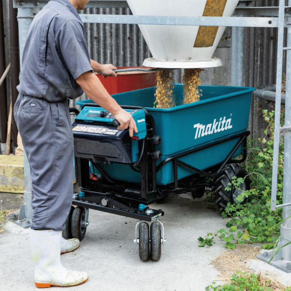 Makita DCU605Z battery powered wheelbarrow being loaded with bulk material on site