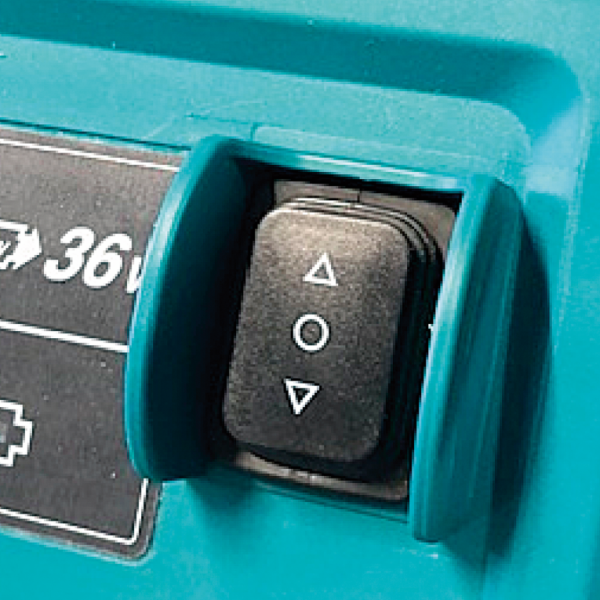 Close-up of the bucket raise and lower switch on the Makita DCU602Z