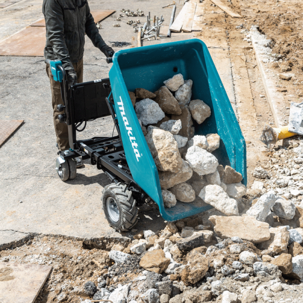 Makita DCU602Z tipping rubble on site using the electric hydraulic bucket