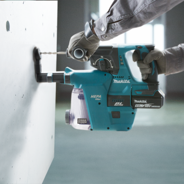 工人手持 Makita DHR242RTE 充電式電錘連集塵器在混凝土牆身鑽孔
