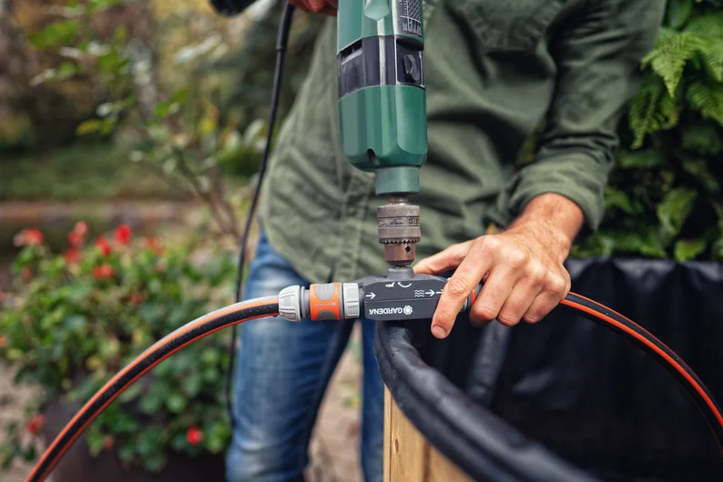 GARDENA 1490-20 Electric Drill Pump connected to a drill and hoses