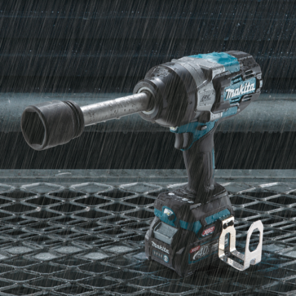 Makita TW011GZ cordless impact wrench in the rain, showing XPT dust and drip resistance