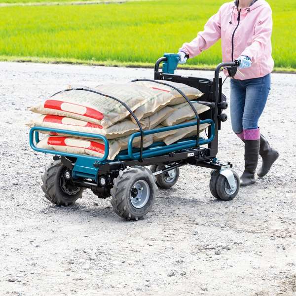 Makita DCU604Z battery powered wheelbarrow carrying sacks of material on gravel