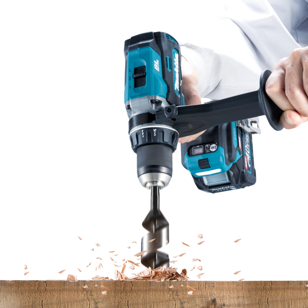 Makita HP003GZ 40V cordless hammer driver drill boring into a timber beam with an auger bit