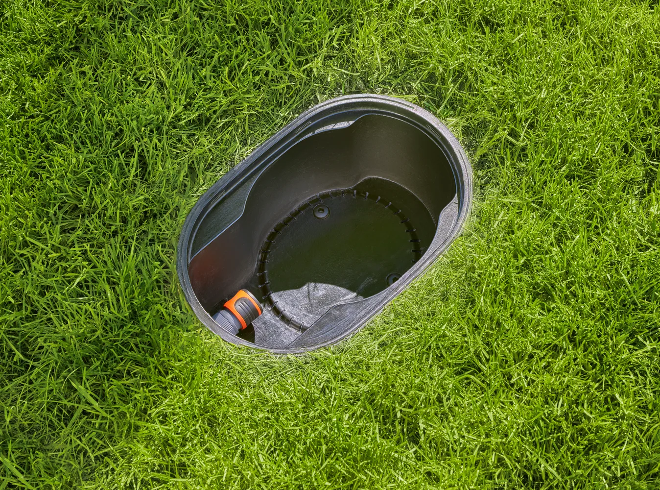 GARDENA AquaPrecise Pipeline Box installed in a lawn