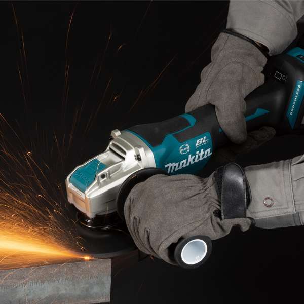工人手持 Makita DGA519Z 18V 充電角向磨光機切割金屬並產生火花
