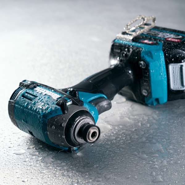 Makita TD003GA201 impact driver covered in water droplets, showing XPT dust and drip resistant construction